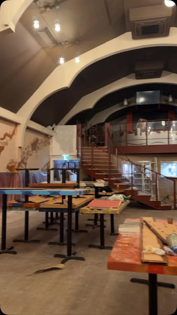 Tables covered with design samples inside Tavern Co. Social during the fit-out